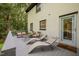 Comfortable seating populates the back deck of this beautiful home in a lush wooded lot at 6817 Guess Rd, Hillsborough, NC 27278