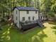 Charming home featuring a spacious back deck ideal for outdoor gatherings and overlooking the serene wooded lot at 6817 Guess Rd, Hillsborough, NC 27278
