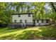 Back of home showing the deck and lush surrounding yard at 6817 Guess Rd, Hillsborough, NC 27278