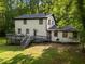 Charming home featuring a spacious back deck ideal for outdoor gatherings and overlooking the serene wooded lot at 6817 Guess Rd, Hillsborough, NC 27278