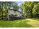 Spacious backyard with large deck, mature trees and well manicured lawn at 6817 Guess Rd, Hillsborough, NC 27278