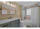 Clean bathroom with tile surround shower and vanity with marble countertop at 6817 Guess Rd, Hillsborough, NC 27278