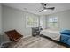Bright bedroom with two windows, desk, chair, and overhead ceiling fan at 6817 Guess Rd, Hillsborough, NC 27278