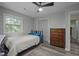 Bright bedroom featuring a large window, closet space, and modern flooring at 6817 Guess Rd, Hillsborough, NC 27278