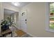 Inviting entryway with modern gray floors, fresh paint, and a security system at 6817 Guess Rd, Hillsborough, NC 27278