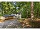 Charming two-story home featuring a covered carport, inviting entrance, and surrounding trees at 6817 Guess Rd, Hillsborough, NC 27278