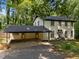Two-story home with attached portico has mature landscaping at 6817 Guess Rd, Hillsborough, NC 27278
