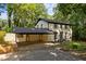 Traditional white brick home featuring a convenient carport and well-manicured front yard, surrounded by mature trees at 6817 Guess Rd, Hillsborough, NC 27278