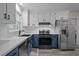 Charming kitchen featuring white subway tile backsplash, stainless appliances, and two-tone cabinets at 6817 Guess Rd, Hillsborough, NC 27278