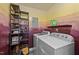 Functional laundry room with washer, dryer and shelving for storage at 6817 Guess Rd, Hillsborough, NC 27278
