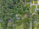 Bird's-eye view showcases a cozy home nestled amidst lush greenery and mature trees at 705 Wilsons Mills Rd, Smithfield, NC 27577