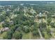 Aerial view featuring a well-treed neighborhood, highlighting a mix of residences at 705 Wilsons Mills Rd, Smithfield, NC 27577
