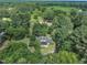 Aerial view reveals a charming home nestled among mature trees on a spacious lot at 705 Wilsons Mills Rd, Smithfield, NC 27577