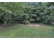 A lush backyard with mature trees, offering a private and serene outdoor space at 705 Wilsons Mills Rd, Smithfield, NC 27577
