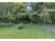 A serene backyard featuring a lush lawn, bird bath, and decorative bird houses at 705 Wilsons Mills Rd, Smithfield, NC 27577