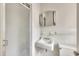 Bathroom with a walk-in shower, decorative mirror, and tiled walls at 705 Wilsons Mills Rd, Smithfield, NC 27577