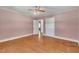 Bedroom with hardwood floors, closet space, and access to hallway at 705 Wilsons Mills Rd, Smithfield, NC 27577