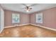 Bedroom with two windows, ceiling fan, and hardwood floors at 705 Wilsons Mills Rd, Smithfield, NC 27577