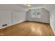 Attic bedroom with hardwood floors, a closet, a light fixture, and a bright window at 705 Wilsons Mills Rd, Smithfield, NC 27577