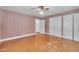 Bedroom featuring hardwood floors, ceiling fan, and closet space at 705 Wilsons Mills Rd, Smithfield, NC 27577