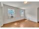 Bedroom with hardwood floors, two windows, and an air conditioning unit at 705 Wilsons Mills Rd, Smithfield, NC 27577