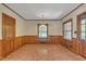 An empty dining room with wood paneled walls, a window and brick floors at 705 Wilsons Mills Rd, Smithfield, NC 27577
