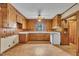 A cozy kitchen features wood cabinets, a classic white appliance, and a window with a view to the outdoors at 705 Wilsons Mills Rd, Smithfield, NC 27577