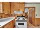 This kitchen features pine cabinets, white countertops and access to the rest of the house at 705 Wilsons Mills Rd, Smithfield, NC 27577