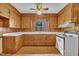 Charming kitchen featuring knotty pine cabinets and a white range centered on a window overlooking the back yard at 705 Wilsons Mills Rd, Smithfield, NC 27577