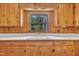 Kitchen close-up featuring a bright sink and view of the outdoors at 705 Wilsons Mills Rd, Smithfield, NC 27577