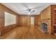 Spacious living room with wood paneling, hardwood floors, and fireplace at 705 Wilsons Mills Rd, Smithfield, NC 27577