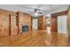 Cozy living room featuring wood-paneled walls, fireplace, and hardwood floors at 705 Wilsons Mills Rd, Smithfield, NC 27577