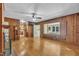 Spacious living room with wood-paneled walls, hardwood floors, and a large picture window at 705 Wilsons Mills Rd, Smithfield, NC 27577