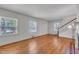 Living room with hardwood floors, a classic fireplace, and large windows that bring in natural light at 705 Wilsons Mills Rd, Smithfield, NC 27577