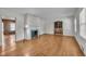 Living room featuring hardwood floors, fireplace with decorative tile, and access to a den at 705 Wilsons Mills Rd, Smithfield, NC 27577