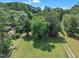 Aerial view showcasing lush trees, an expansive green lawn, and a private driveway at 705 Wilsons Mills Rd, Smithfield, NC 27577