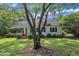 Mature trees and lush landscaping complement this charming single-story home at 705 Wilsons Mills Rd, Smithfield, NC 27577