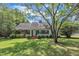 Well-maintained lawn, mature trees surround this charming single-story home at 705 Wilsons Mills Rd, Smithfield, NC 27577