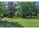 Manicured lawn and mature trees showcase this charming single-story home at 705 Wilsons Mills Rd, Smithfield, NC 27577