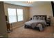 Cozy bedroom with a comfortable bed, bedside tables, and plenty of natural light from large windows at 825 Fulworth Ave, Wake Forest, NC 27587