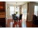 An ample dining area featuring a glass table, leather chairs, natural light, and hardwood flooring at 825 Fulworth Ave, Wake Forest, NC 27587