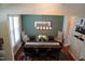 Bright dining room with hardwood floors, neutral walls, dining table set for six at 825 Fulworth Ave, Wake Forest, NC 27587