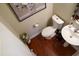 Clean half bathroom featuring tile floors, a toilet, and a small white pedestal sink at 825 Fulworth Ave, Wake Forest, NC 27587