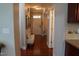 Hallway featuring hardwood floors, a decorative bench, and neutral paint at 825 Fulworth Ave, Wake Forest, NC 27587