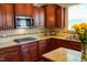 Traditional kitchen featuring cherry wood cabinets, granite countertops, and stainless steel appliances at 825 Fulworth Ave, Wake Forest, NC 27587