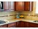 Traditional kitchen featuring cherry wood cabinets, granite countertops, decorative backsplash, and recessed lighting at 825 Fulworth Ave, Wake Forest, NC 27587