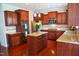 Kitchen with stainless steel appliances, granite counters, wood cabinets and hardwood floors at 825 Fulworth Ave, Wake Forest, NC 27587