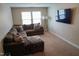 Relaxing living room featuring a plush sectional sofa, carpet, and a wall-mounted TV for entertainment at 825 Fulworth Ave, Wake Forest, NC 27587