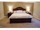 A spacious main bedroom featuring neutral tones, a plush carpet, and a decorative bed frame with ornate trim at 825 Fulworth Ave, Wake Forest, NC 27587