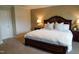 A spacious main bedroom featuring neutral tones, a plush carpet, and an ornate wooden bed frame with lamps at 825 Fulworth Ave, Wake Forest, NC 27587